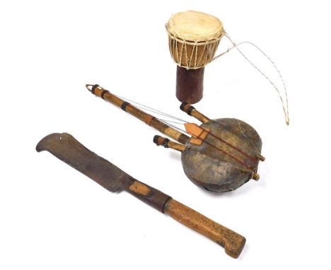 An African string plucked and hide bound folk lute, 49cm high, Africa Djenbe drum, 21cm high, and a cast iron and wooden bill