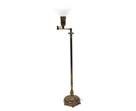 A brass adjustable lamp, with white opaque holophane type shade, reeded column and domed base, 146cm high.&nbsp;Buyer Note: W