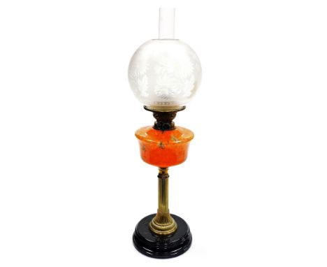 A late 19thC brass and glass oil lamp, with an acid etched floral decorated shade, clear glass chimney, a mottled orange and 