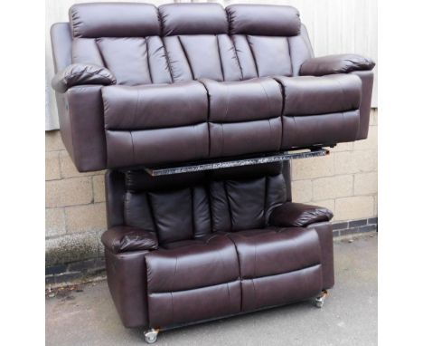 A 20thC brown leather three seater manual reclining sofa, together with a matching two seater sofa. The upholstery in this lo