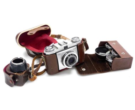 A Zeiss Icon Contina camera, with a 1:2,8F=45mm lens, cased, together with a box of Voigtlander filters, cased, and a Kodak l