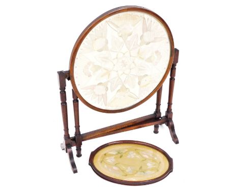 A 1920s mahogany framed metamorphic fire screen table, with circular glazed silk embroidery panel to the top/screen, on slend