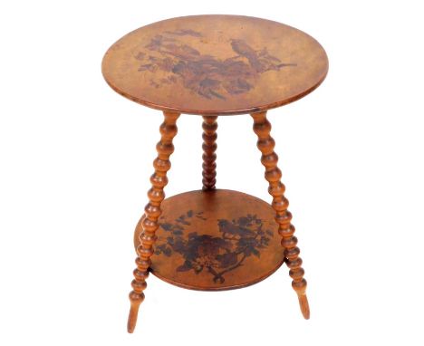 A late Victorian satin birch and poker work gypsy table, the circular top on bobbin turned supports with under tier, decorate