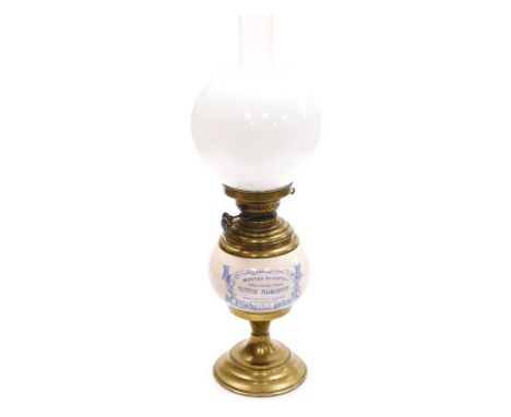 An early 20thC pottery and brass advertising oil lamp, the reservoir printed in blue and white with "Mortar Bluepill, Graduat
