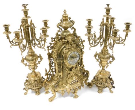 A 20thC German rococo style brass clock garniture, the clock with brass dial bearing enamel Roman numerals, eight day movemen