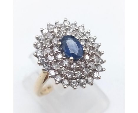 A 14 K yellow gold ring with a central sapphire surrounded by diamonds ( 0.6 carats). Ring size M, weight: 5.4 g. 