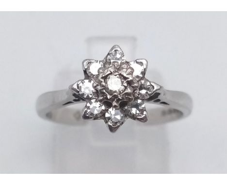 An 18K White Gold Diamond Cluster Ring. Size M. 3.37g 