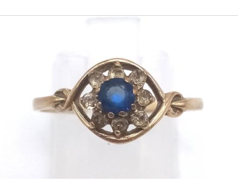 A 9 K yellow gold ring with blue and white stones. Ring size: P, weight: 1.3 g. 