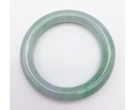 A Green Jade Bangle. 6cm diameter. 
