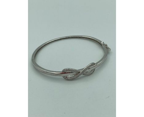 SILVER stone set infinity BANGLE. Having side hinge and safety catch. New and unworn. 