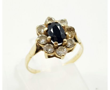 A 9K Yellow Gold Garnet and White Stone Ring. Size M.1.94g 