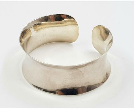 A sterling silver, concave, bangle, Weight: 37.4 g. 