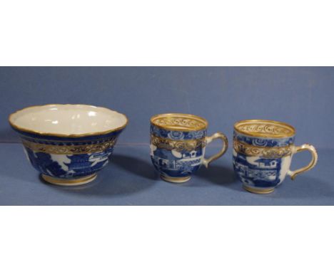 Two early C19th Chinese export ware coffee cups together with a matching sugar bowl. Blue and white decoration with gilt high