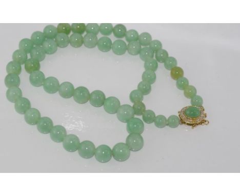 Graduated jade bead necklace with 14ct gold clasp mounted with jade, clasp has attachments where a second string can be added