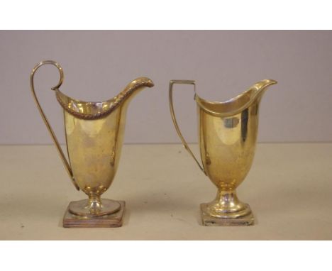 Two Victorian silver plated helmet creamers 13.5cm & 15cm high