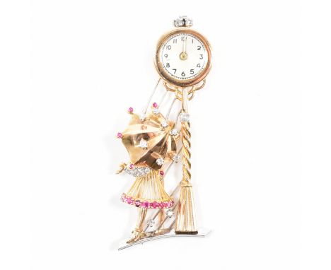 A mid 20th Century French 18ct gold ' girl with umbrella ' ruby and diamond watch brooch circa 1945. The brooch in the form o