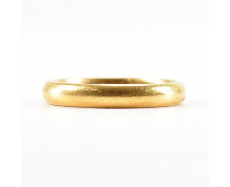 A vintage 22ct gold wedding band ring. The ring of plain D form. Hallmarks rubbed, tests indicate 22ct gold. Weight 5.8g. Siz