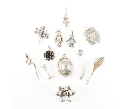 An assorted collection of 925 silver necklace pendants &amp; charms. The lot to include; an etched design oval locket, spiral