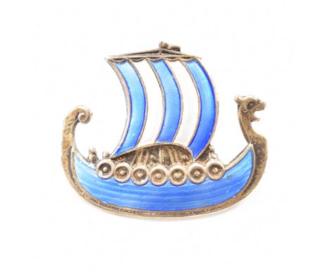 An Ivar Holth sterling silver enamelled long ship brooch pin. The brooch in the form of a Viking boat enamelled with blue &am