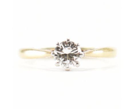 A gold and diamond solitaire ring. The ring being set with a round brilliant cut diamond in a cathedral setting. Marked 18ct 