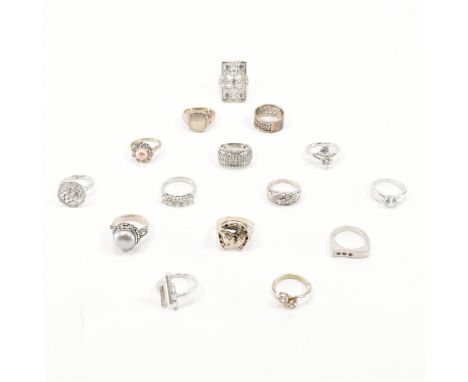 An assorted collection of 925 silver rings. The lot to include; a punched design white stone set tapered shank ring, etched d