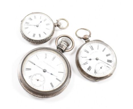 A group of three white metal pocket watches. All having white dials with Roman numeral markers, one with engine turned design