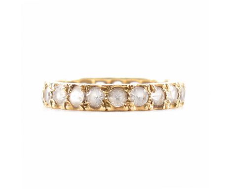 An 18ct gold eternity ring. The ring set with white stones. Gallery marked 18ct tests indicate 18ct gold. Weight 3.4g. Size M