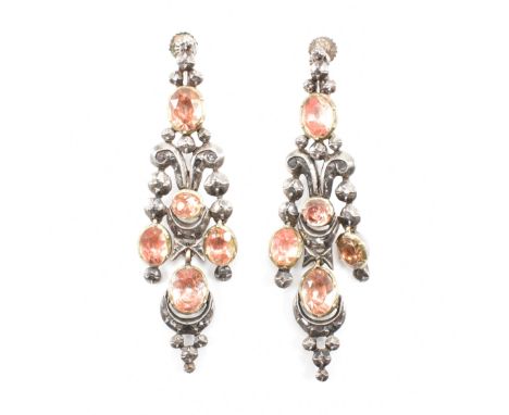 A pair of Georgian antique silver, topaz and diamond drop earrings. The earrings having silver scrolled mounts set with facet