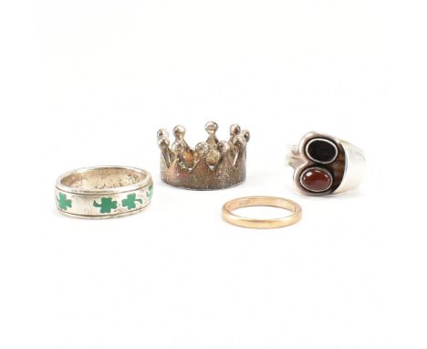 A hallmarked 9ct gold band ring together with three silver rings. The lot to include a silver crown ring, an enamelled sham r