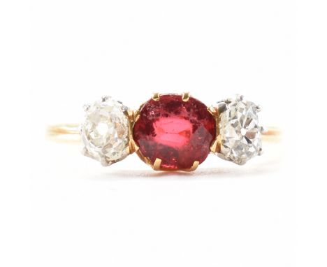 A French hallmarked 18ct yellow gold, diamond &amp; ruby three stone ring. The ring having a central oval cut ruby flanked by