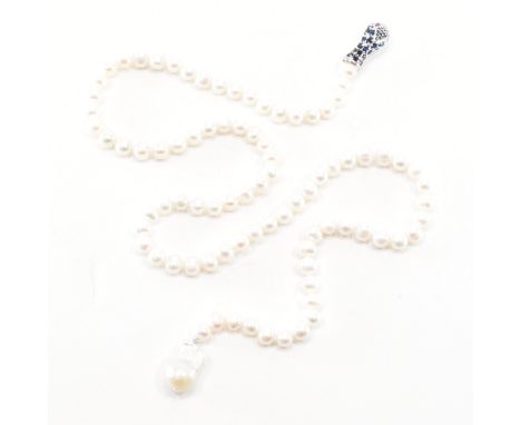 A fresh water pearl, sapphire &amp; ruby snake necklace. The necklace comprised of rounded pearls with a large organic shaped