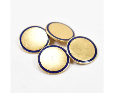 A pair of 18ct gold and enamel cufflinks. The cuff links formed of two roundels framed with blue enamel to outer edges united