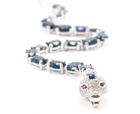 A 925 silver, sapphire, ruby &amp; cubic zirconia snake line bracelet. The bracelet comprised of oval cut sapphires in prong 