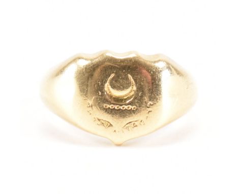 A 19th Century gold signet ring. The ring having a crescent moon and chased decoration to armorial shield head. Weight 9.4g. 