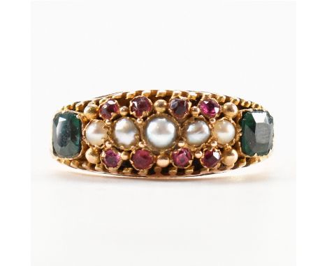 An antique hallmarked 15ct yellow gold, half pearl, ruby &amp; green stone set gypsy ring. The ring having a central row of f