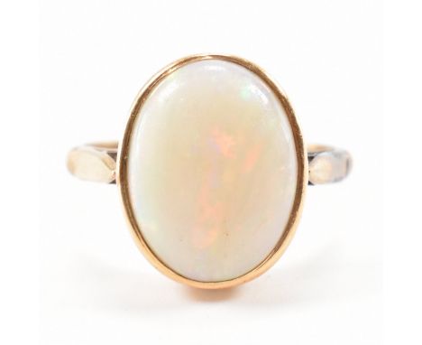 A vintage 9ct gold and opal cabochon ring. The ring set with an opal cabochon to bezel setting having tapering shank. Unmarke