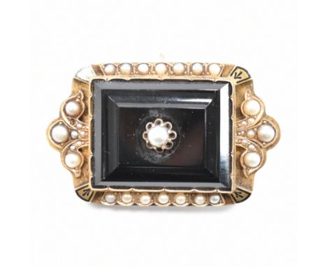 An antique 15ct yellow gold pearl mourning brooch pin. The brooch having a central rectangular cut black stone with a butterc