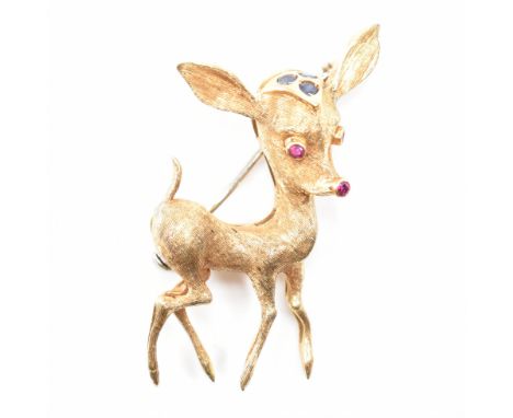 A hallmarked 1960's 18ct gold sapphire and ruby novelty brooch pin. The pin in the form of a fawn having a ruby nose and eyes