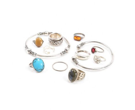 An assorted collection of silver jewellery. The lot to include; wire work decorated bangle bracelet, torque bangle, fidget ri