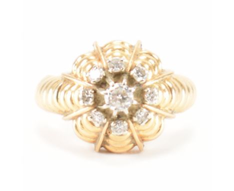 A vintage French and diamond cluster ring. The ring being set with a round cut diamond to the centre with a halo of diamonds 