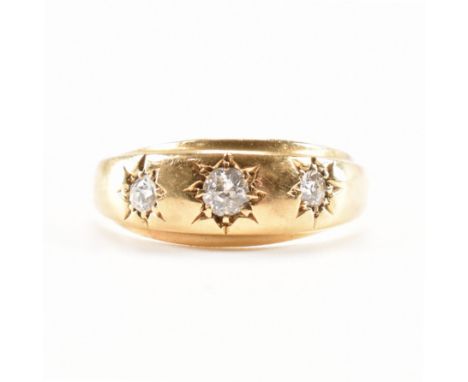 A hallmarked 18ct gold and diamond three stone ring. The ring being set with three round cut diamonds. Hallmarked Birmingham 