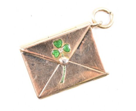 A vintage gold and enamel envelope charm pendant. The envelope having an enamelled shamrock over the seal set with a diamond.