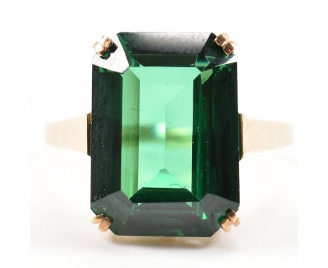 A hallmarked 9ct gold and green synthetic spinel ring. The ring being set with an emerald cut green synthetic spinel on cathe