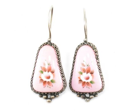 A pair of antique early 20th Century silver and enamel drop earrings. The earrings having triangular enamelled drops with flo