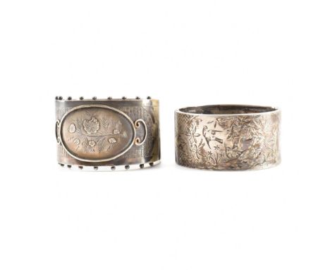 Two Victorian white metal hinged bangle bracelets. The first having a central cartouche marked out in wire work boarders cont
