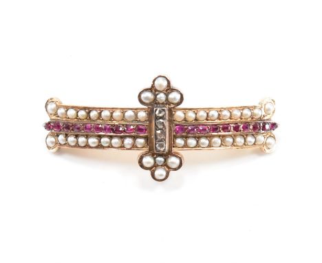 A diamond ruby and pearl brooch pin. The brooch set with a central row of old cut rubies framed by half cut pearls with four 