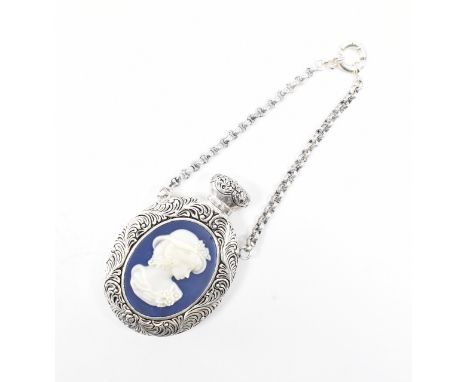 An 800 silver Victorian style cameo set perfume bottle pendant. The bottle of oval form decorated throughout with scrolling f