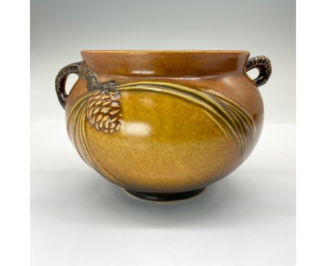 This jardiniere / planter features small ovoid pine cones in raised relief with long pine needles and irregular branch shaped