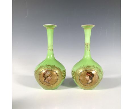 This set includes two small green ceramic vases featuring a long narrow neck and bulbous body, adorned with ornate gilded det