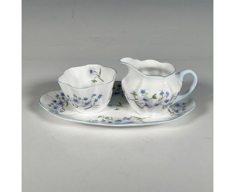 This vintage porcelain set is in the Blue Rock pattern 13591 and features delicate blue flowers on green stems and edged in l